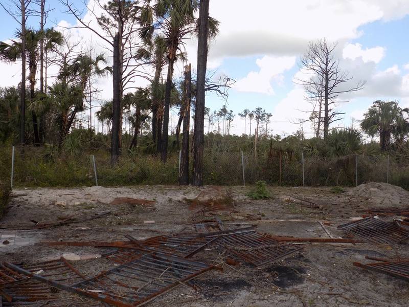 Burned remnants of a horse stable on an agricultural property after a brush fire
