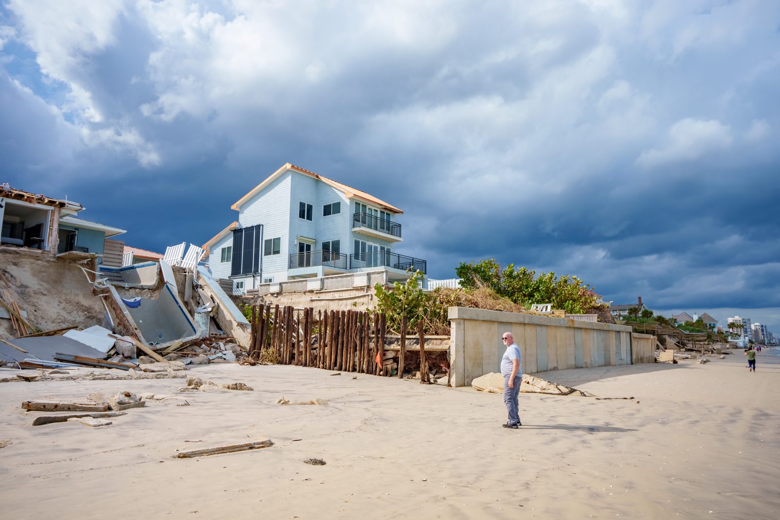 Beach house undermined by hurricane storm surge, foundation exposed