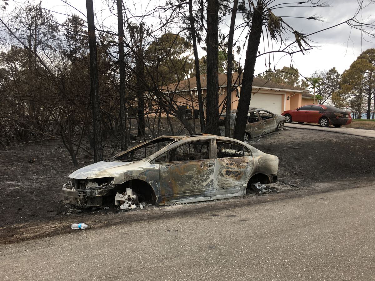 Vehicle destroyed by a brush fire in Lehigh Acres, FL