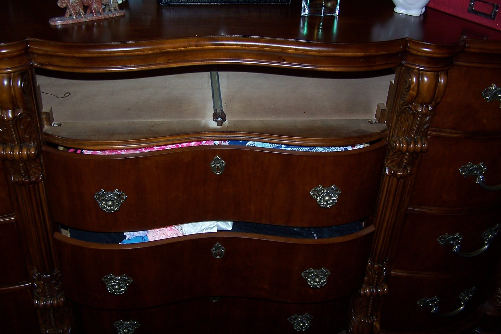 Bedroom dresser with drawers pulled out and ransacked after a burglary