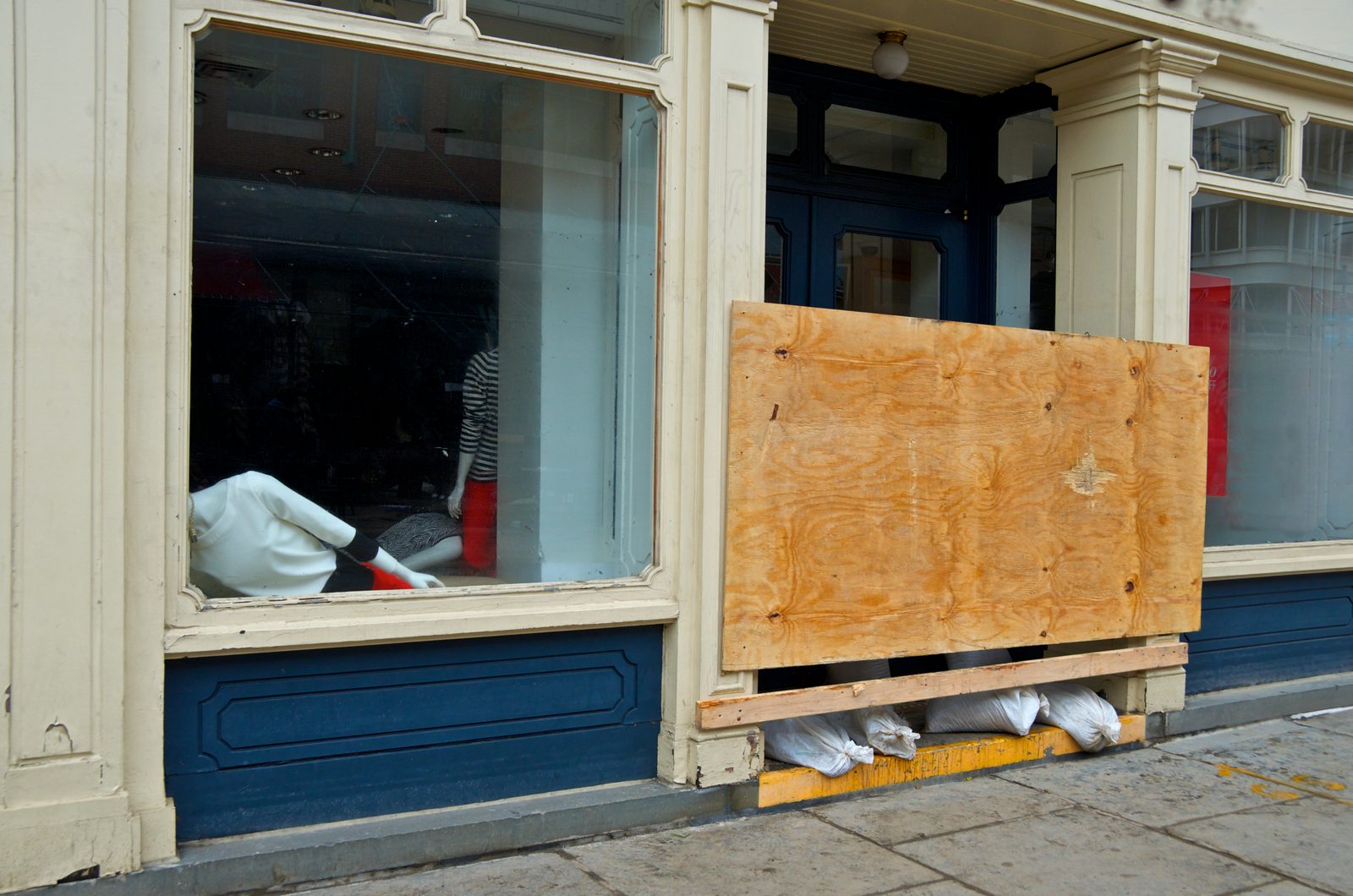 Boarded shop window on a closed storefront