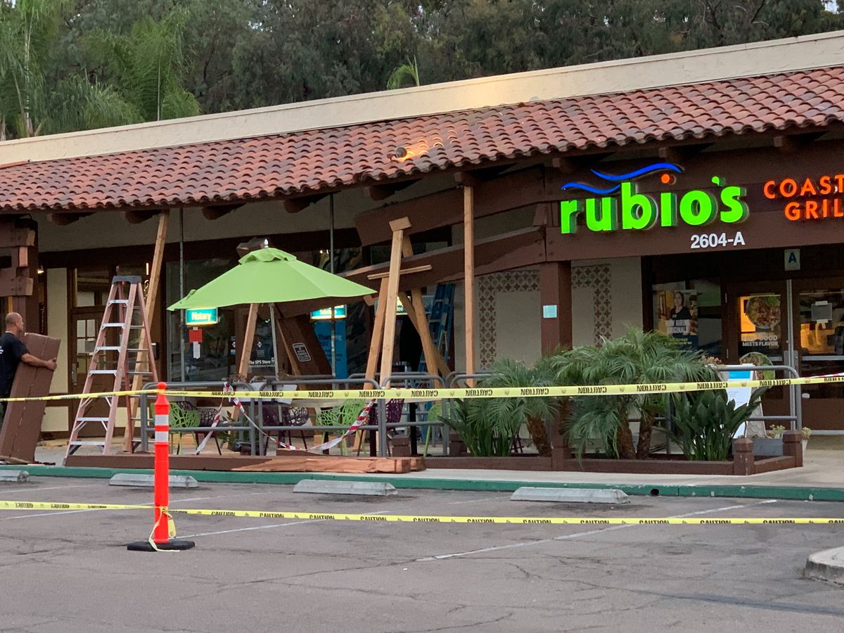 Storefront damage and repair work underway at a commercial retail property