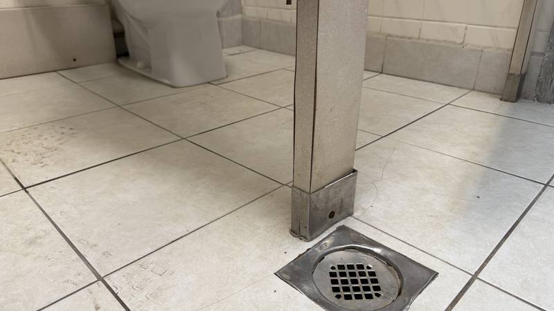 Floor drain and tile flooring in a condo or HOA association common-area restroom