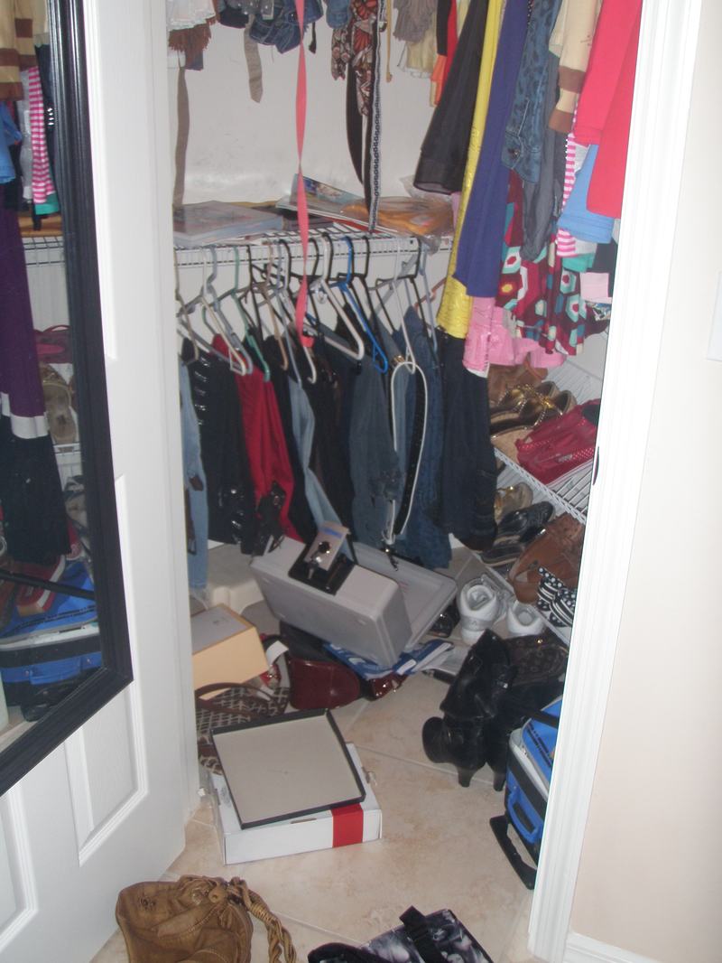Ransacked closet with boxes pulled out and belongings strewn across the floor