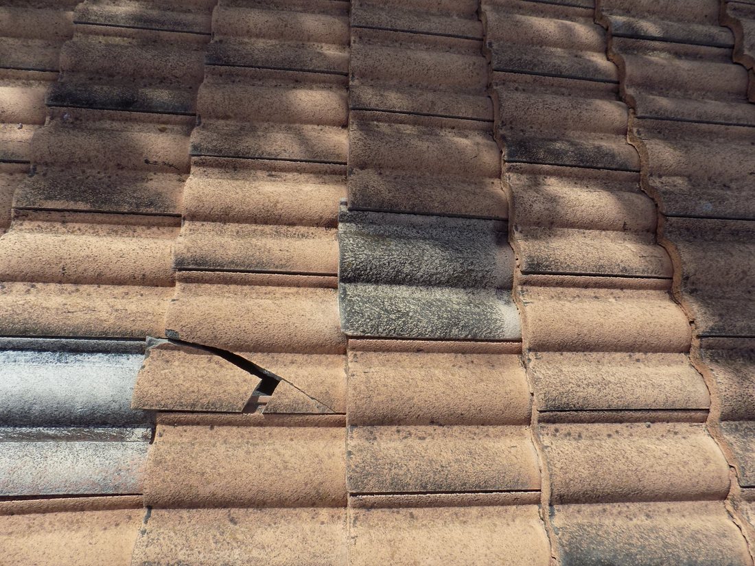 A cracked and mismatched roof tile, the kind of dispute Florida's matching law addresses