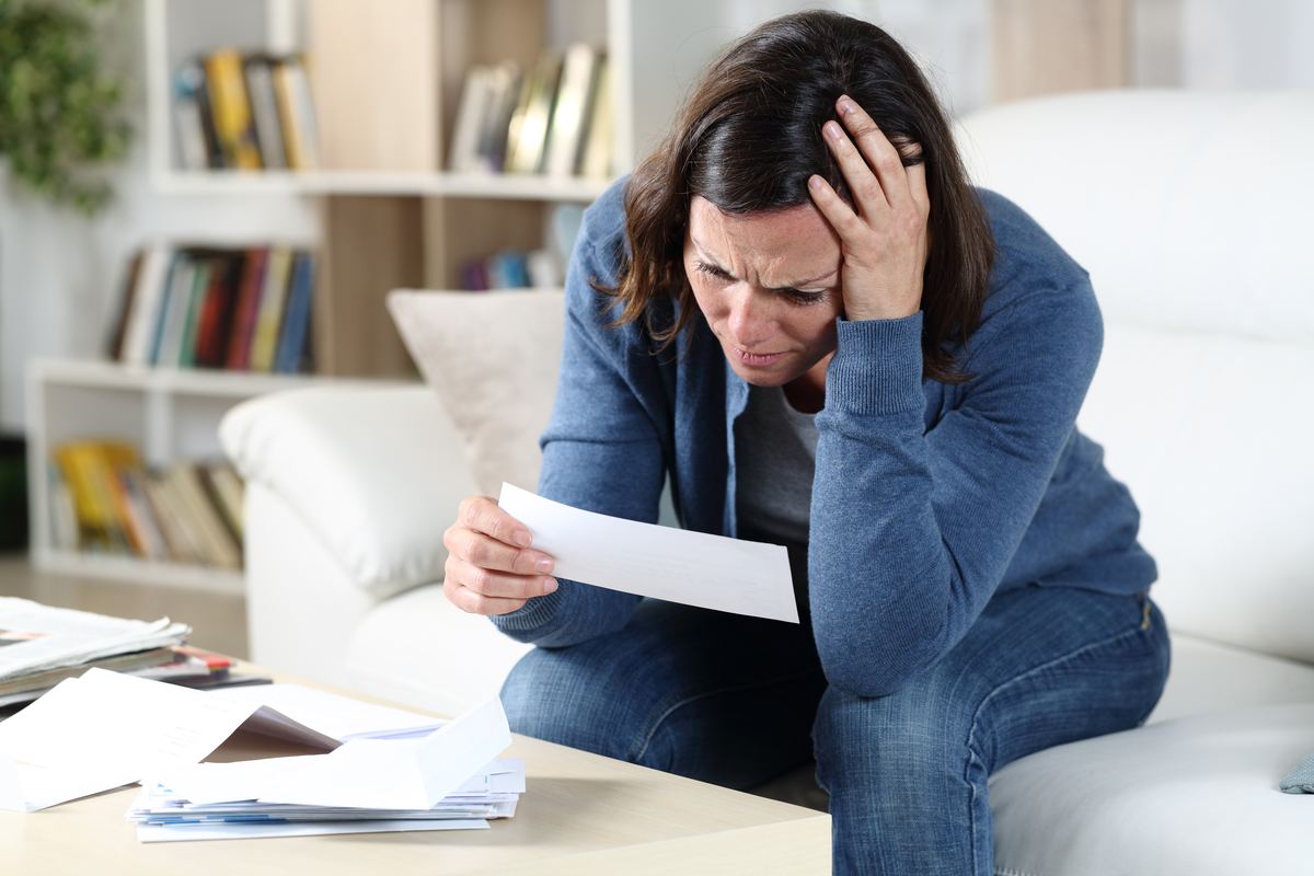 Homeowner reading a denied insurance claim letter