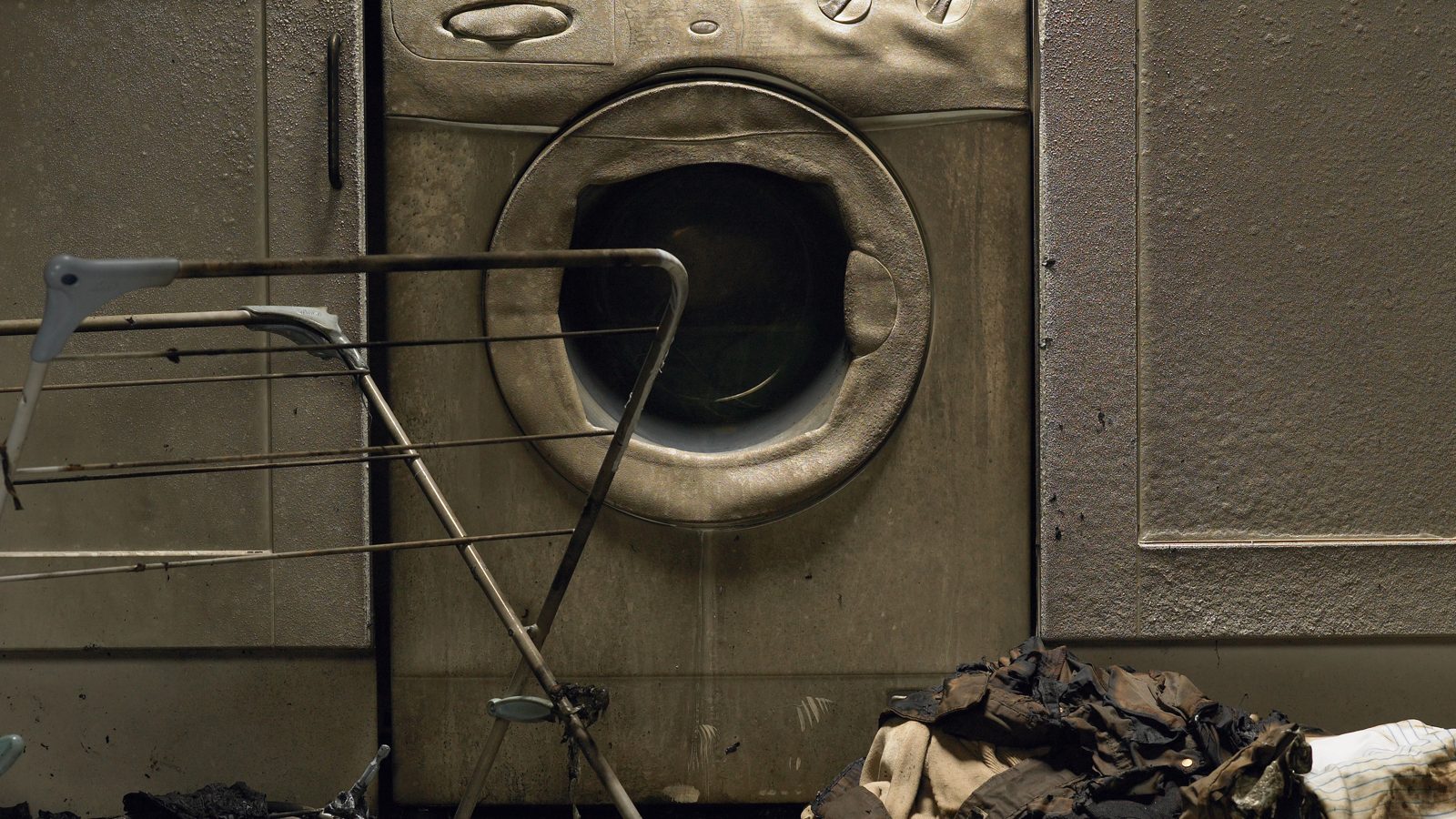 Burned washer and dryer in a laundry room after a dryer fire