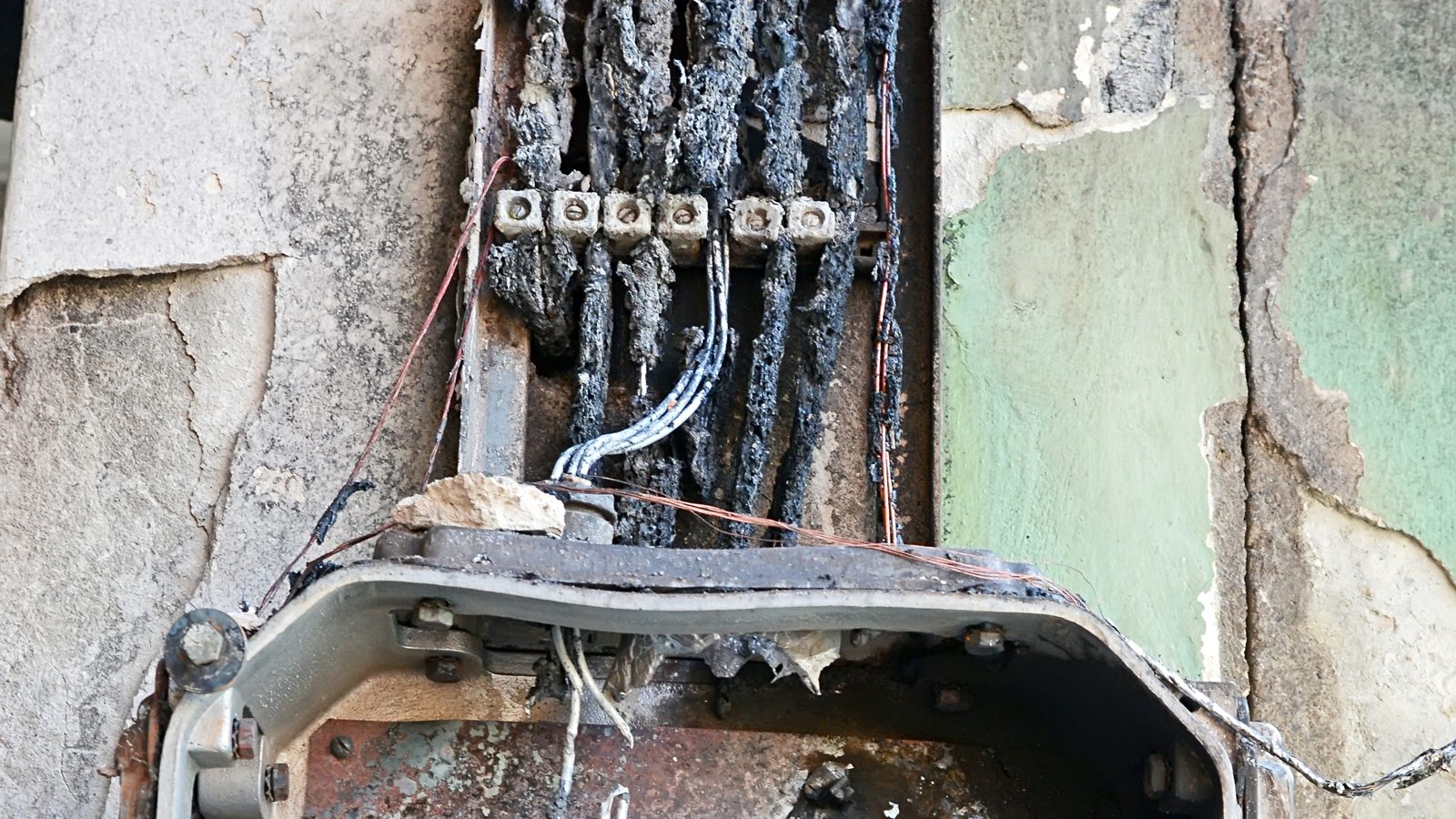 Burned electrical meter and breaker box after an electrical fire