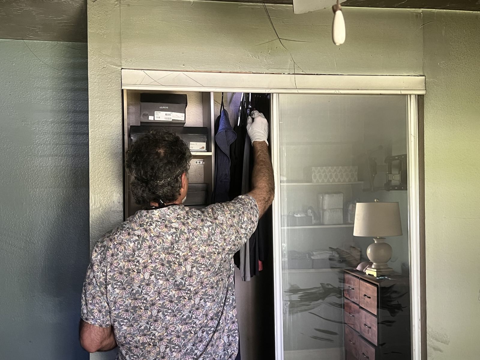Smoke-damaged closet and contents being documented after a fire in a multi-unit building