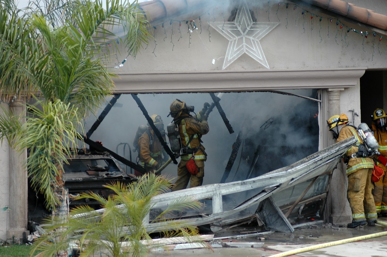 Firefighters extinguishing a garage fire at a Florida home