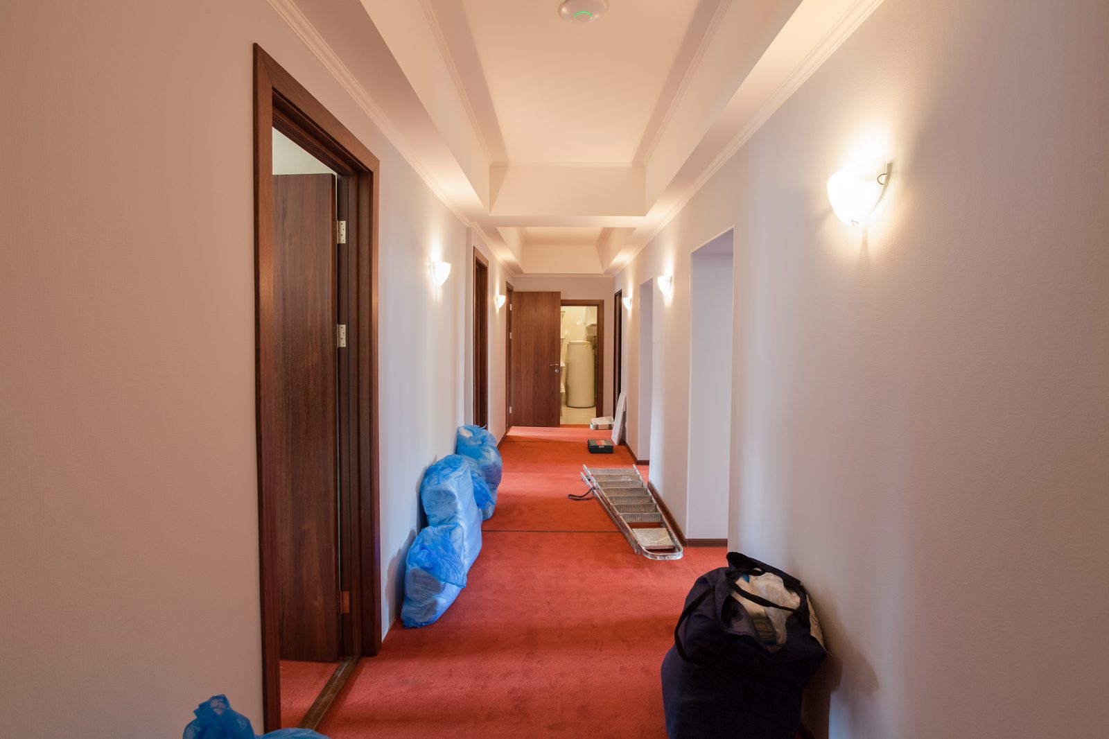 Hotel corridor lined with air movers after water damage