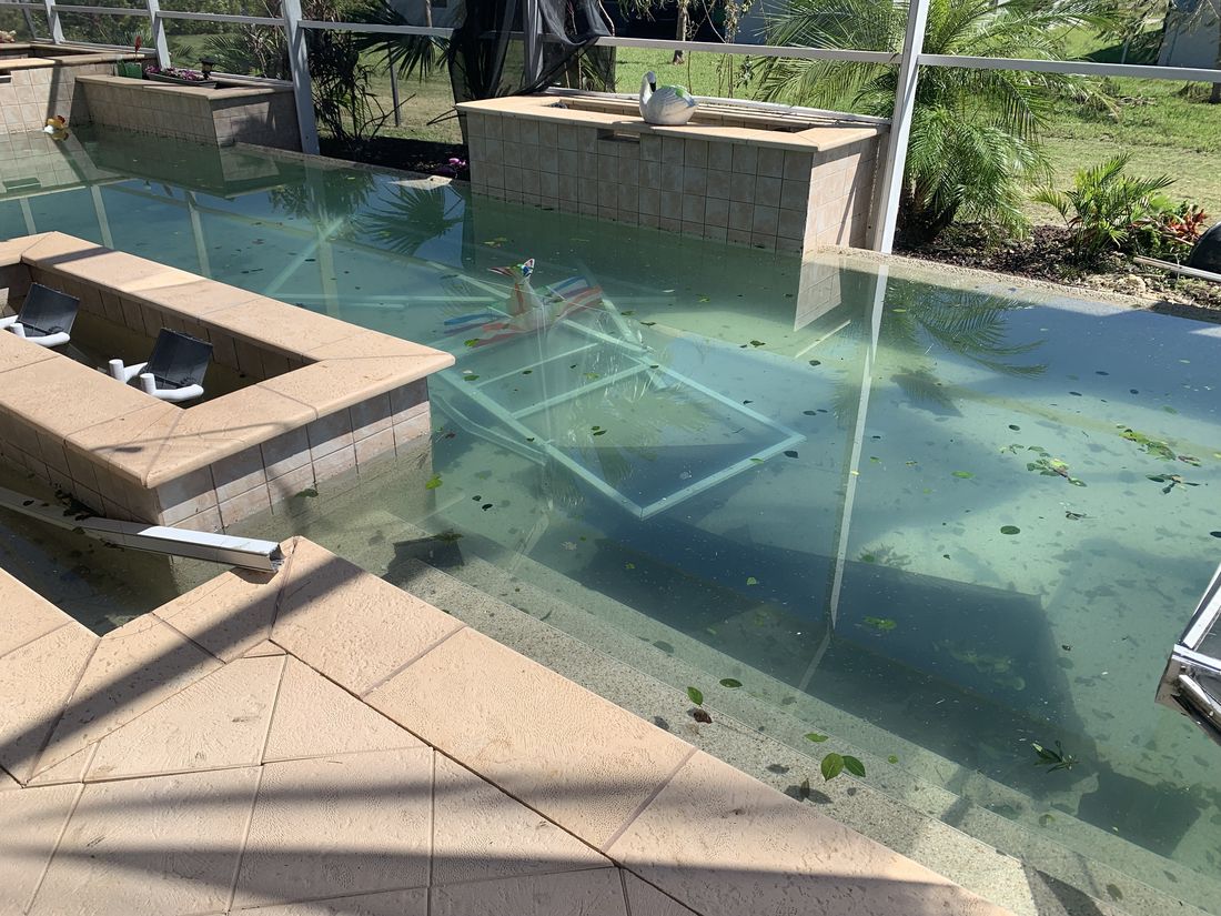 Hurricane debris and a collapsed enclosure in a backyard pool — the kind of claim Homeland handles for Stuart, FL property owners