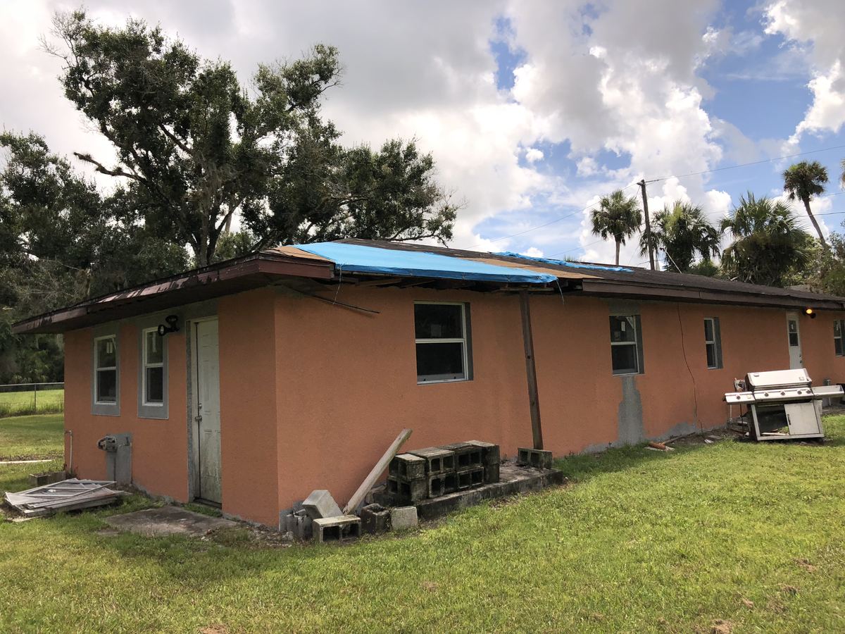 Hurricane roof damage at a home in Belle Glade, FL