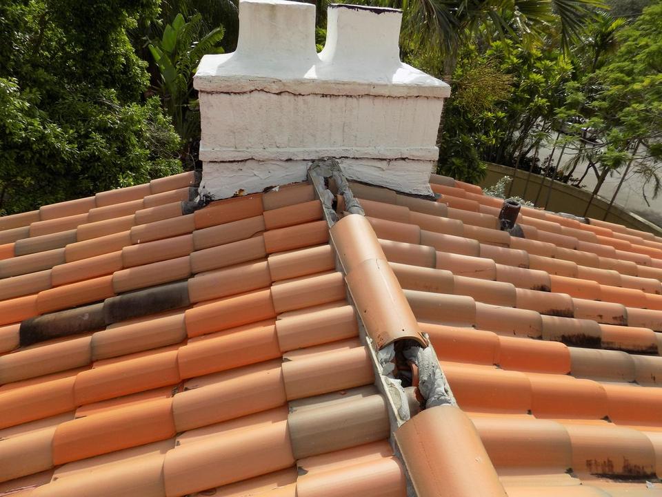 Hurricane damage to clay tile roofing and flashing at a home in Coral Gables, FL