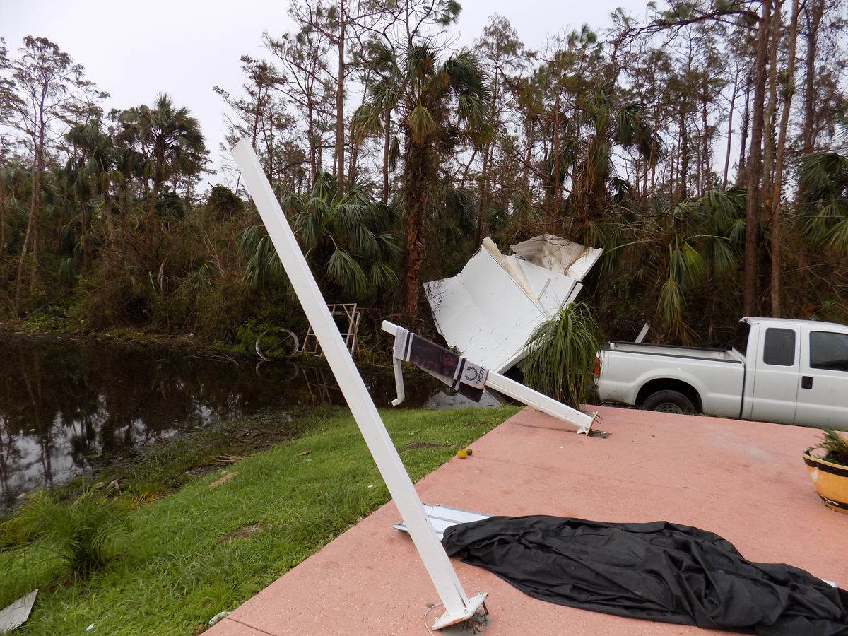 Collapsed lanai and wind damage after a hurricane in Naples, FL