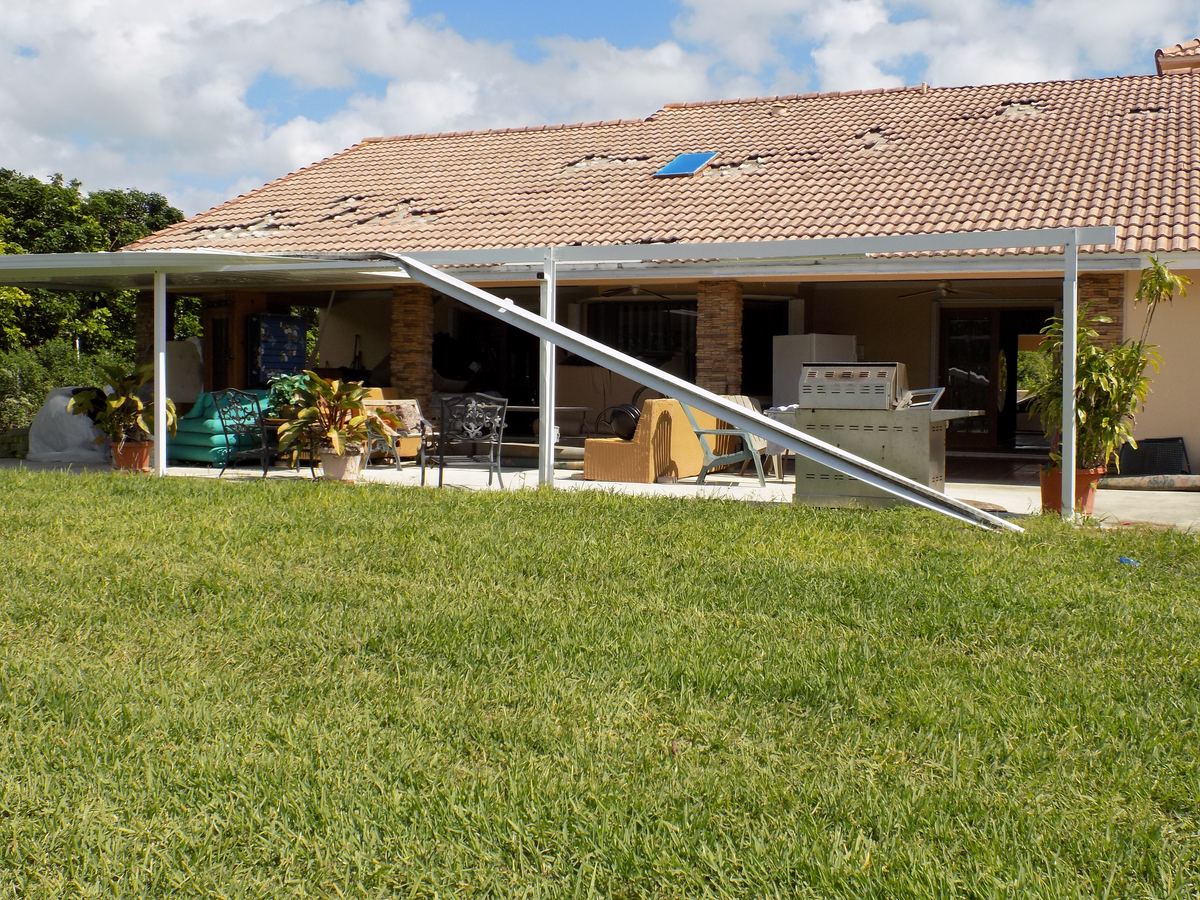 Collapsed patio cover and exterior wind damage at a home in Miami, FL