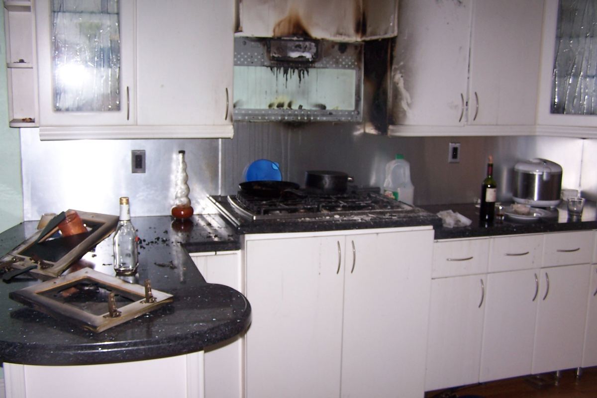 Burned cabinets and range after a kitchen fire in an Orlando, Florida home