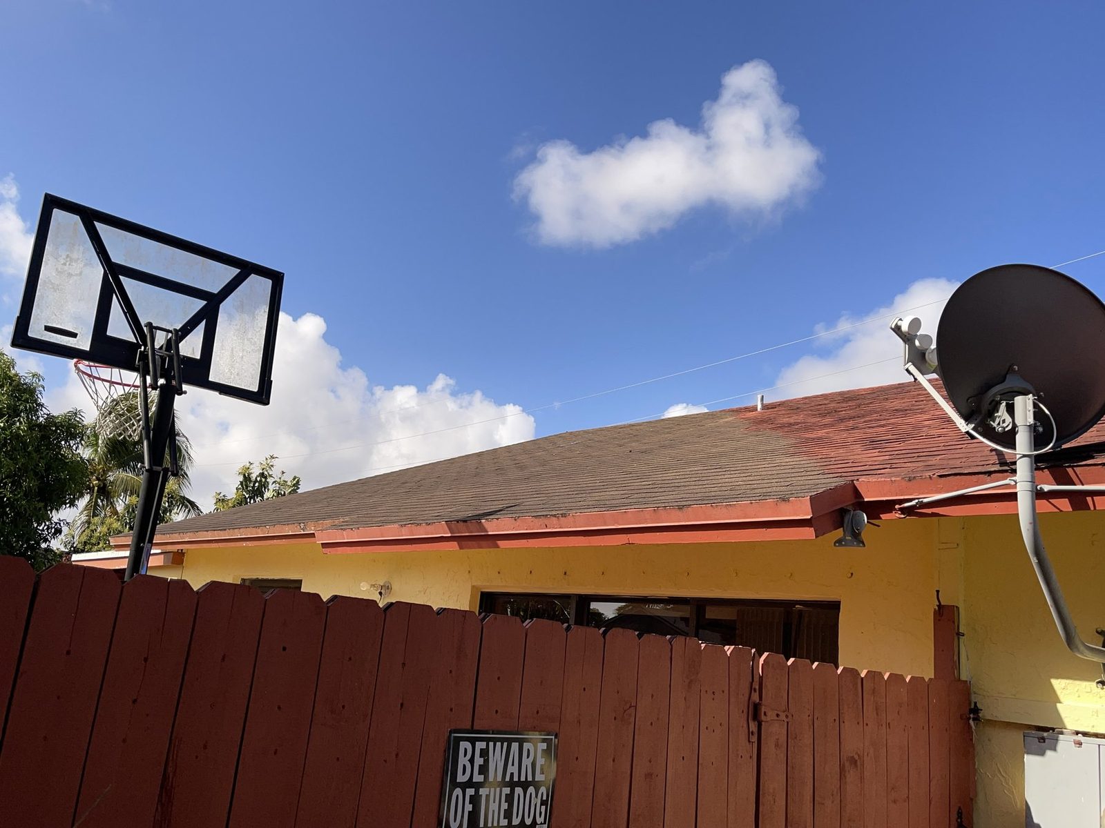 House roof with a patched section of mismatched shingles