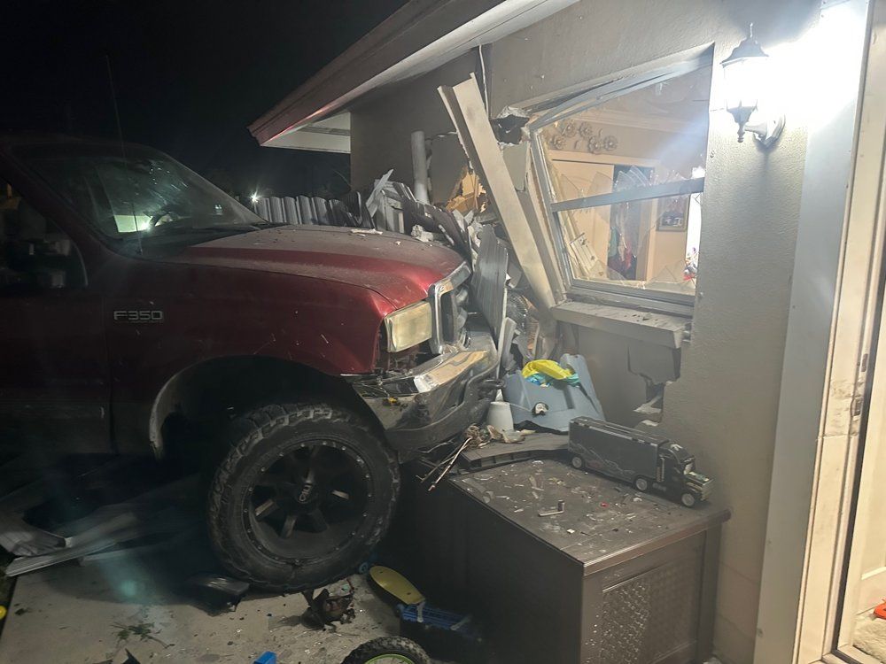 Pickup truck crashed into a garage causing property damage