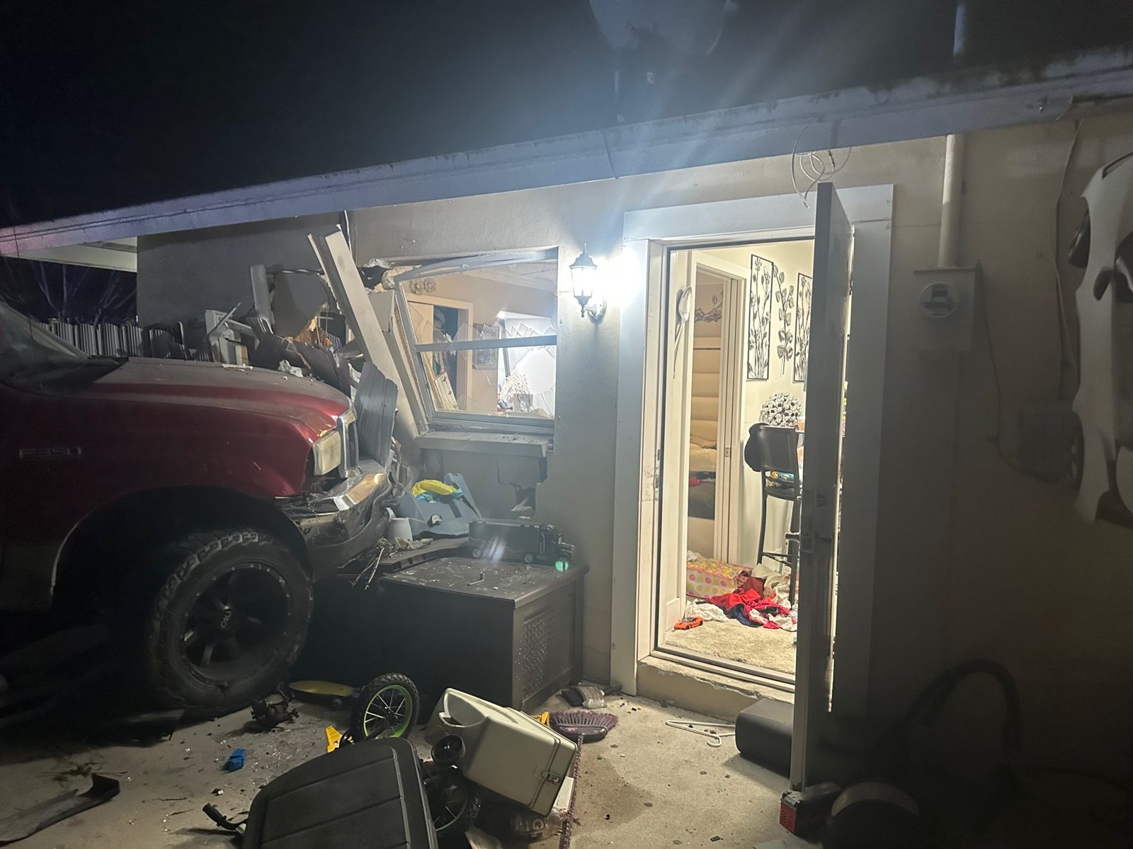 Pickup truck that crashed through a garage wall, seen from inside the garage