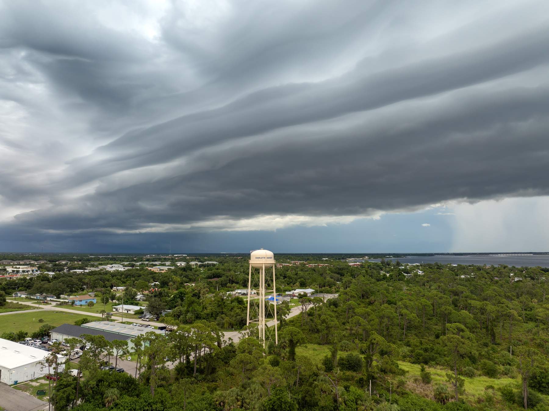 Storm clouds rolling over a water tower in Charlotte County, Florida — Homeland Public Adjusters serves Charlotte County property owners