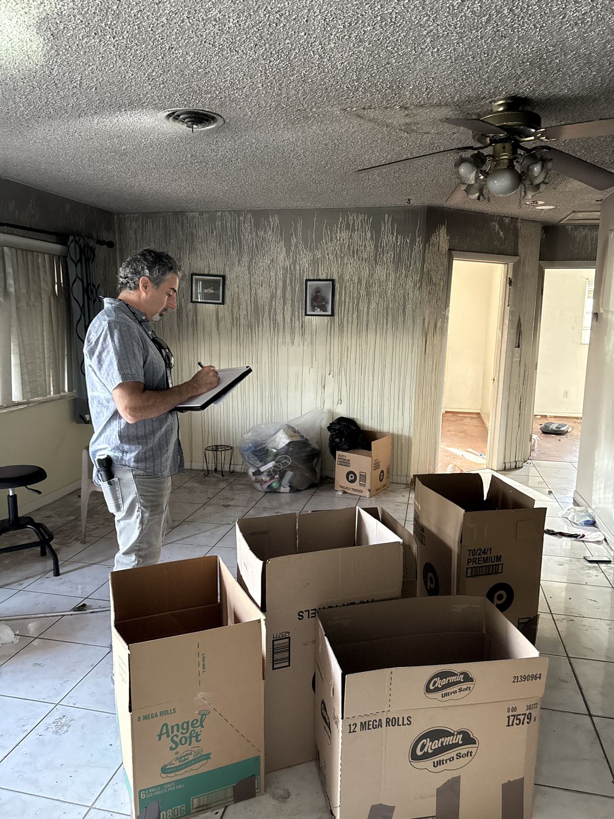 Public adjuster photographing and listing damaged personal property for a renters insurance contents inventory