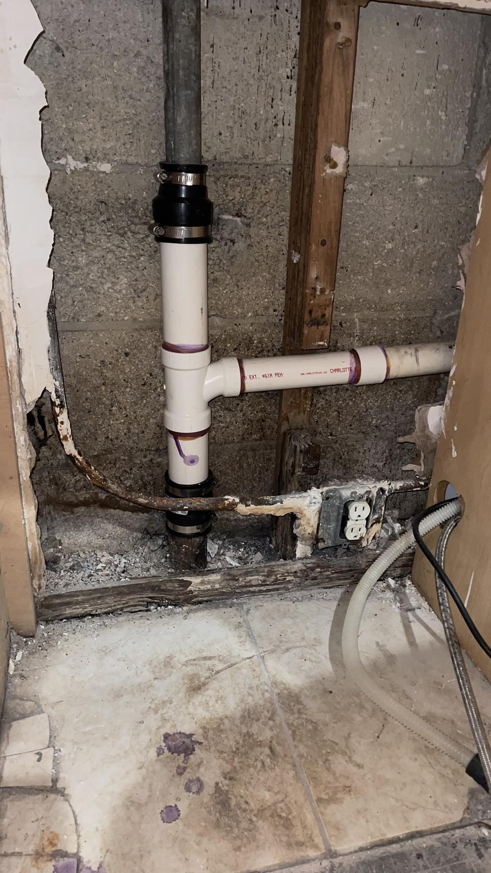 Exposed plumbing and damaged wall during a repair at a home in Hollywood, FL
