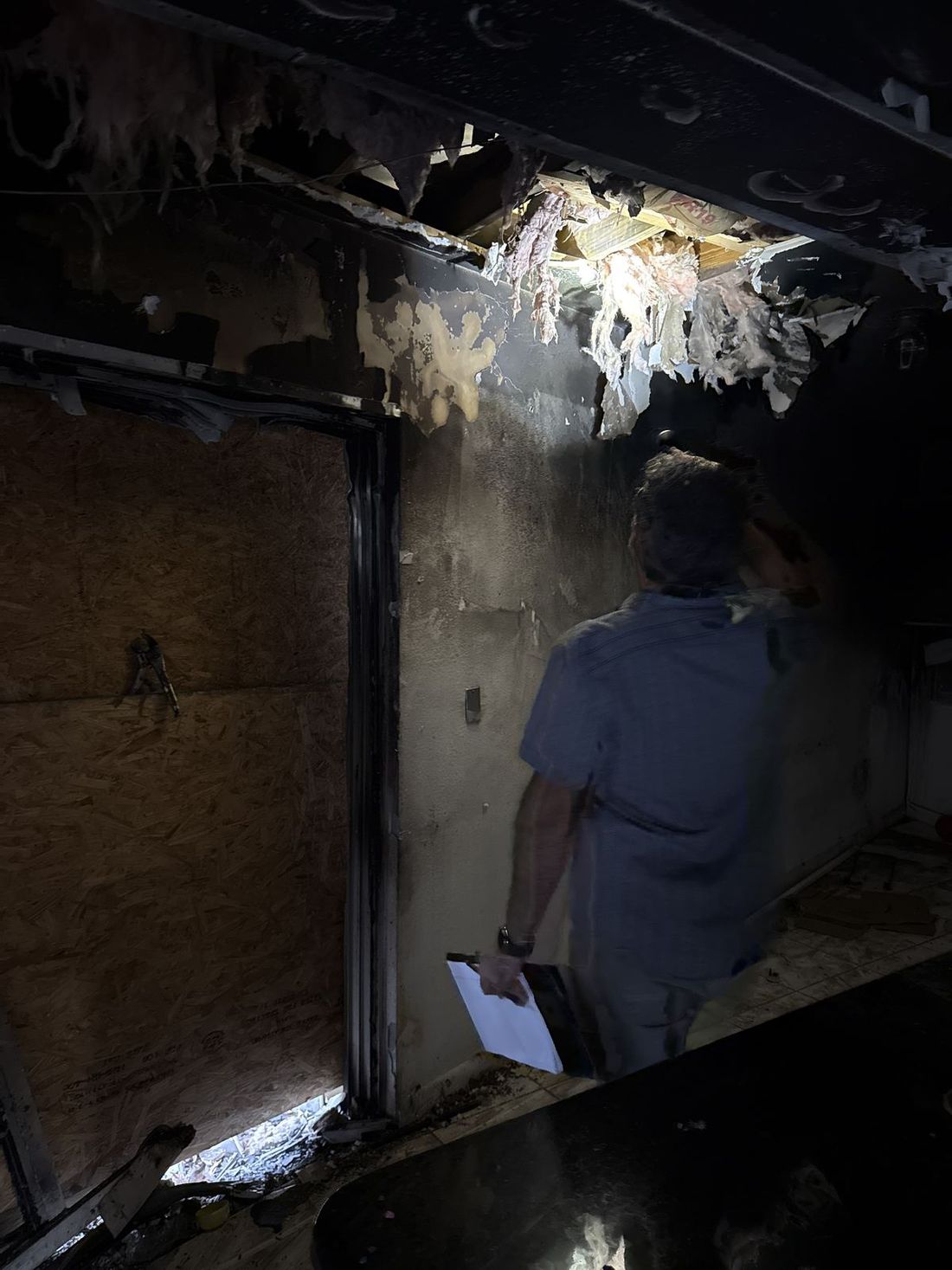Public adjuster inspecting fire damage at a Trenton, New Jersey home