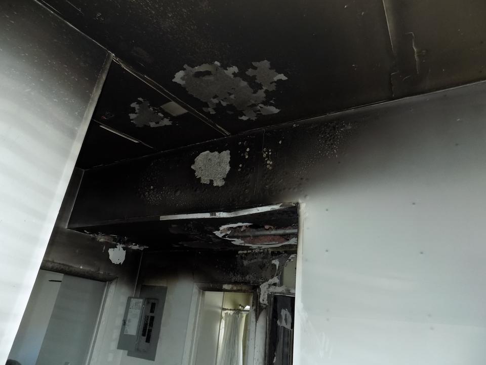 Soot and fire damage to a kitchen ceiling and cabinets at a home in Key Biscayne, FL