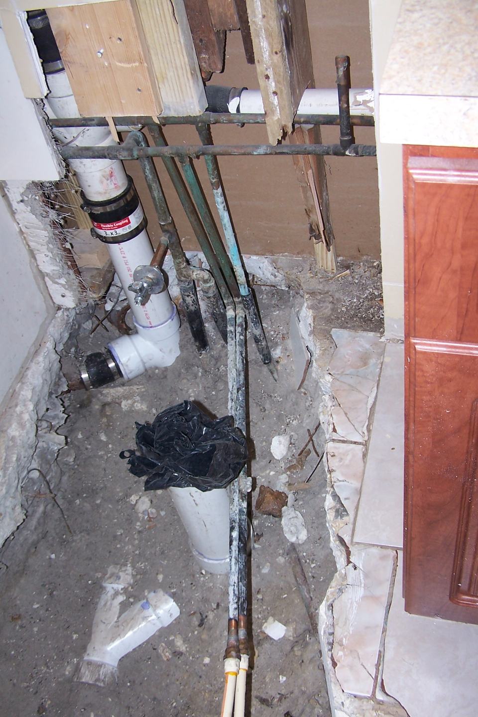 Exposed plumbing behind a water heater during a repair at a home in Miami Lakes, FL