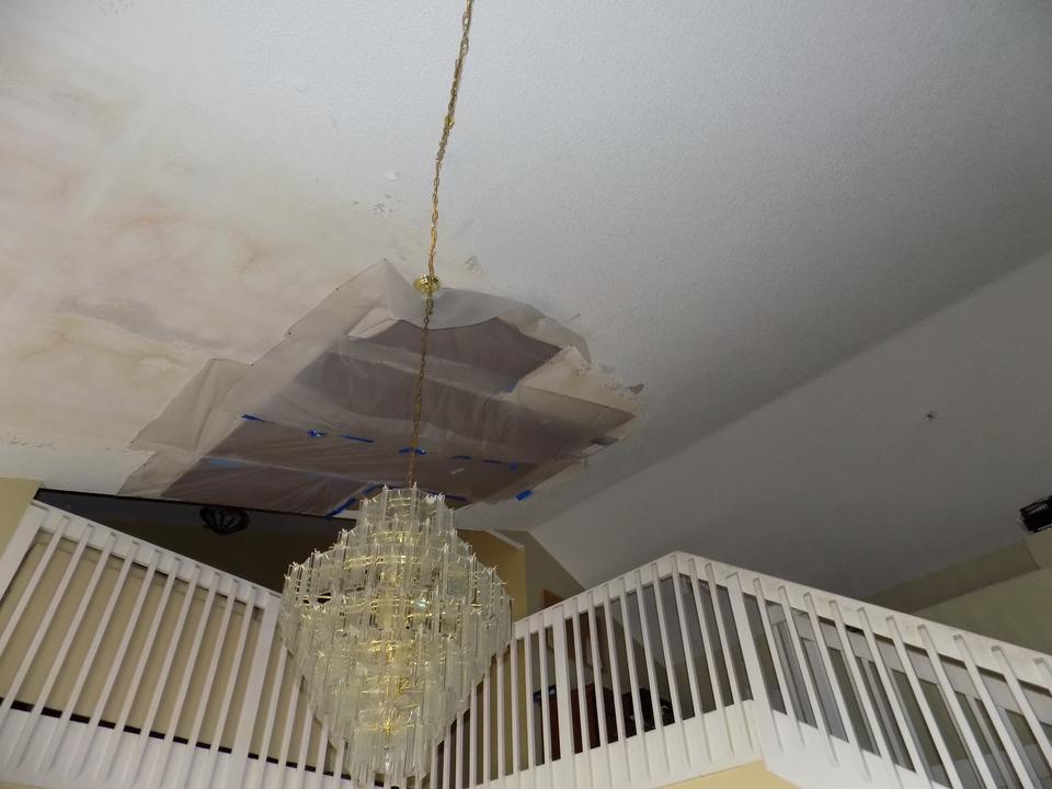 Water-stained ceiling sagging around a chandelier at a home in Pembroke Pines, FL