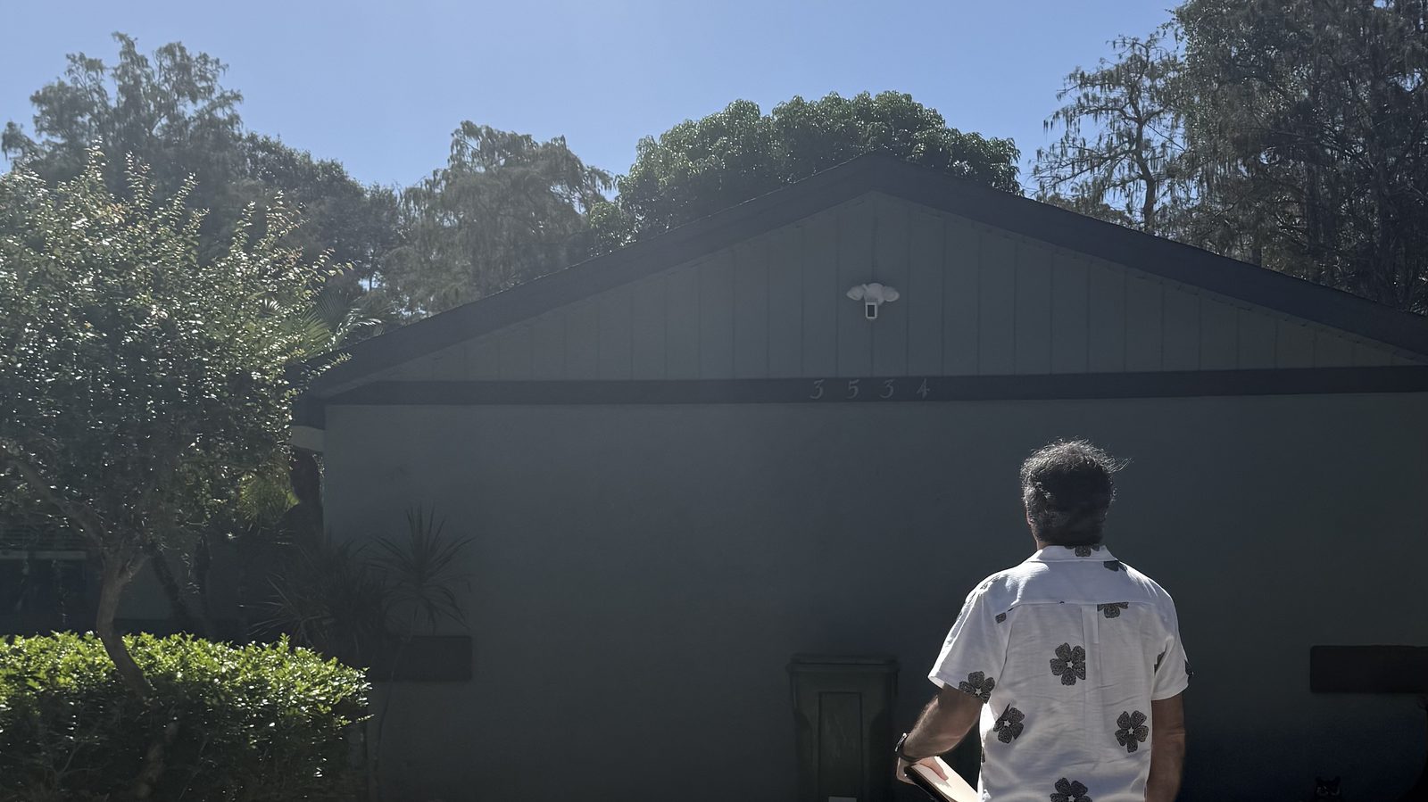 Public adjuster walking a South Florida backyard to inspect storm damage