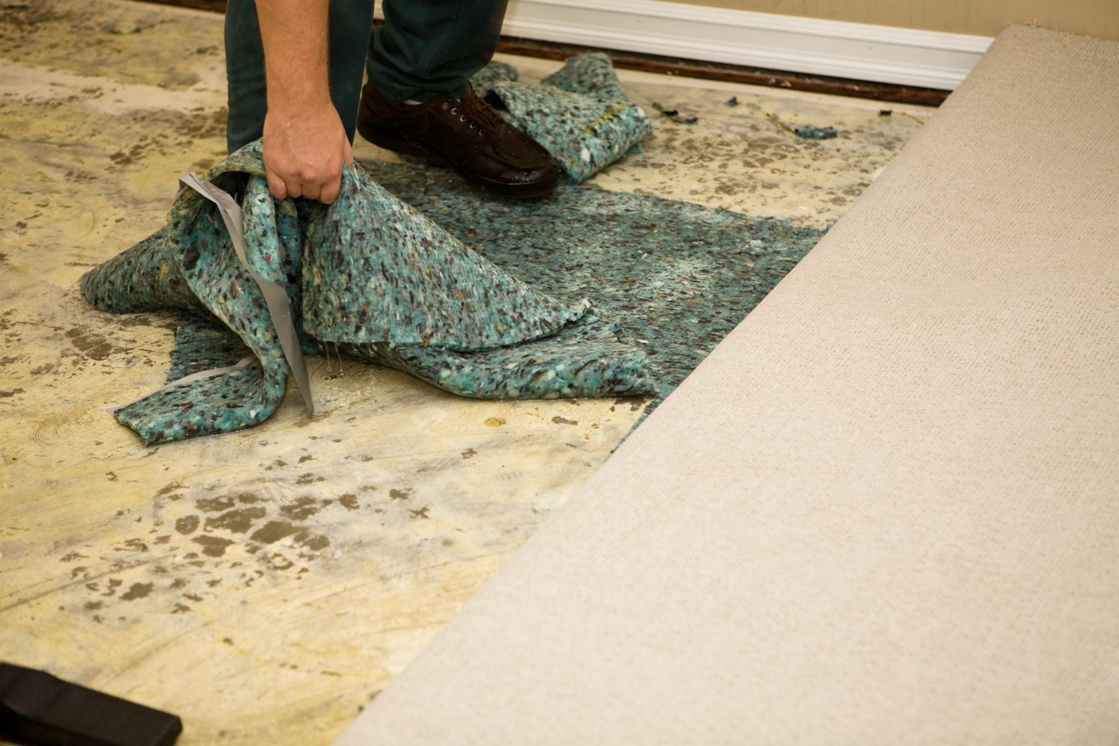 Pulling up moldy, water-damaged carpet in a rental unit
