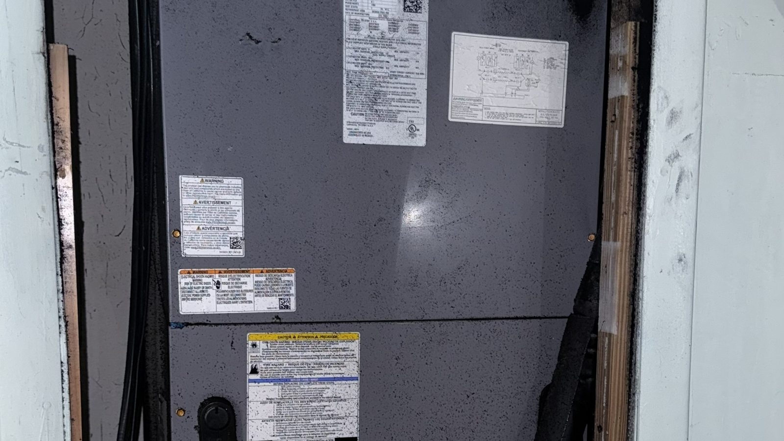 Soot staining on the wall and ceiling around an HVAC air handler after a fire