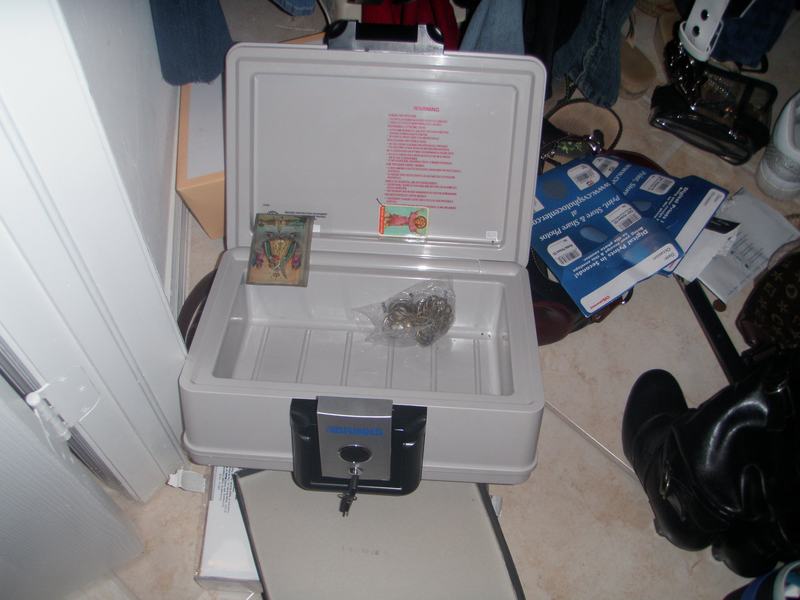 Emptied fireproof safe with only a few items left behind after a burglary