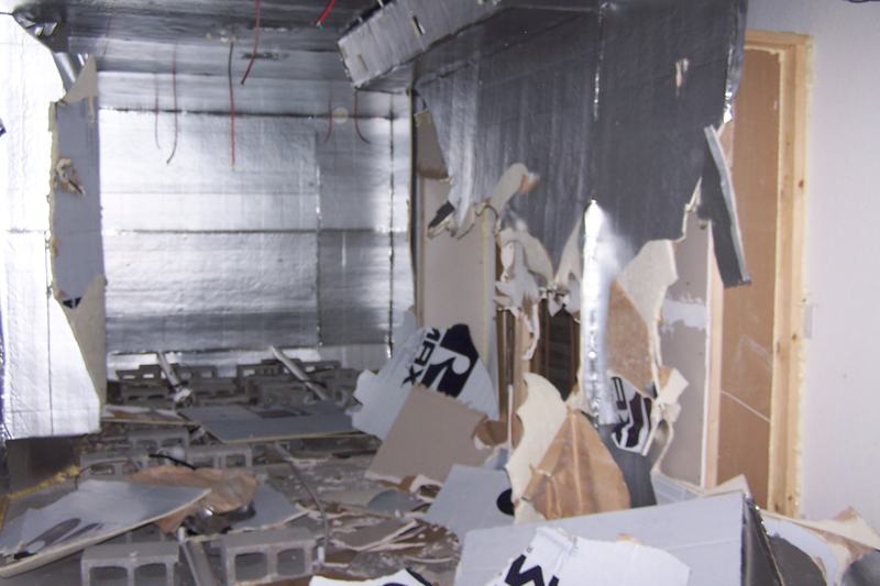 Interior of a Miami rental property gutted by an unauthorized grow operation: stripped drywall, exposed framing and wiring
