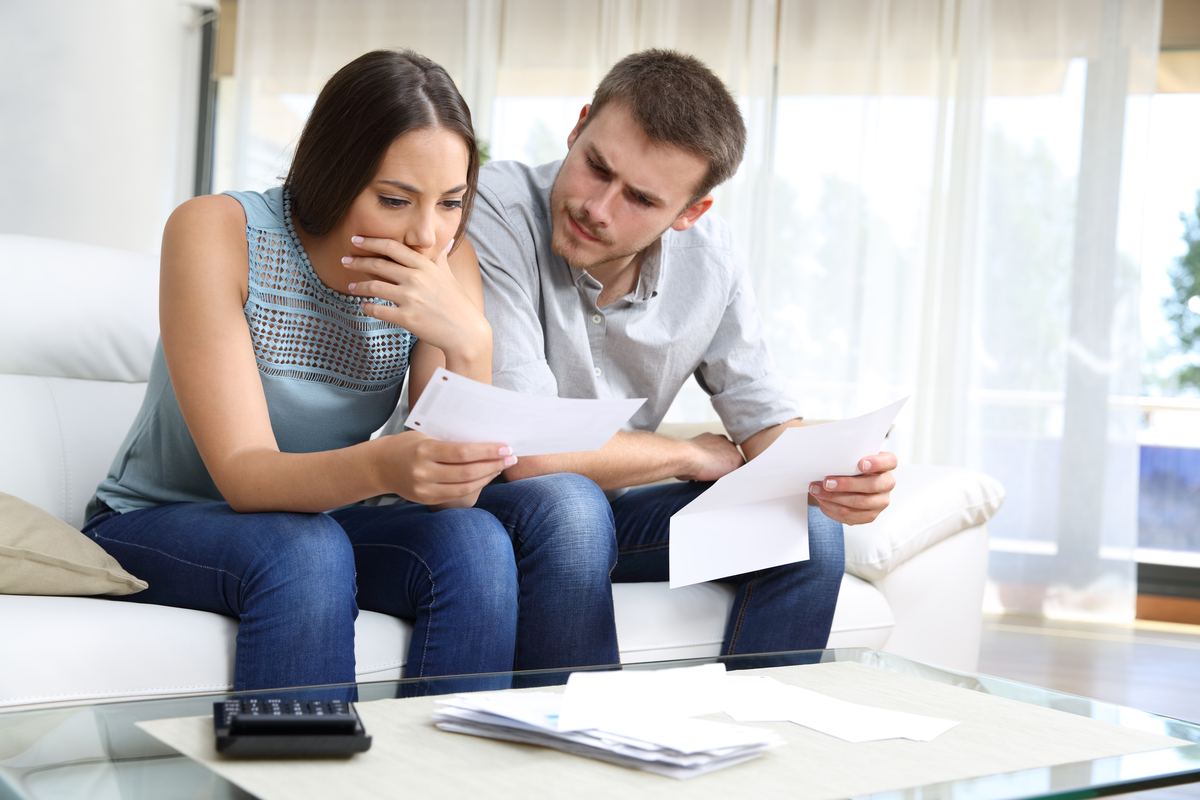 Insurer's estimate, denial letter and policy spread on a desk during a public adjuster's claim review