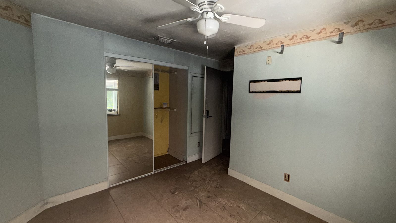 Empty rental unit with smoke-stained walls after a fire