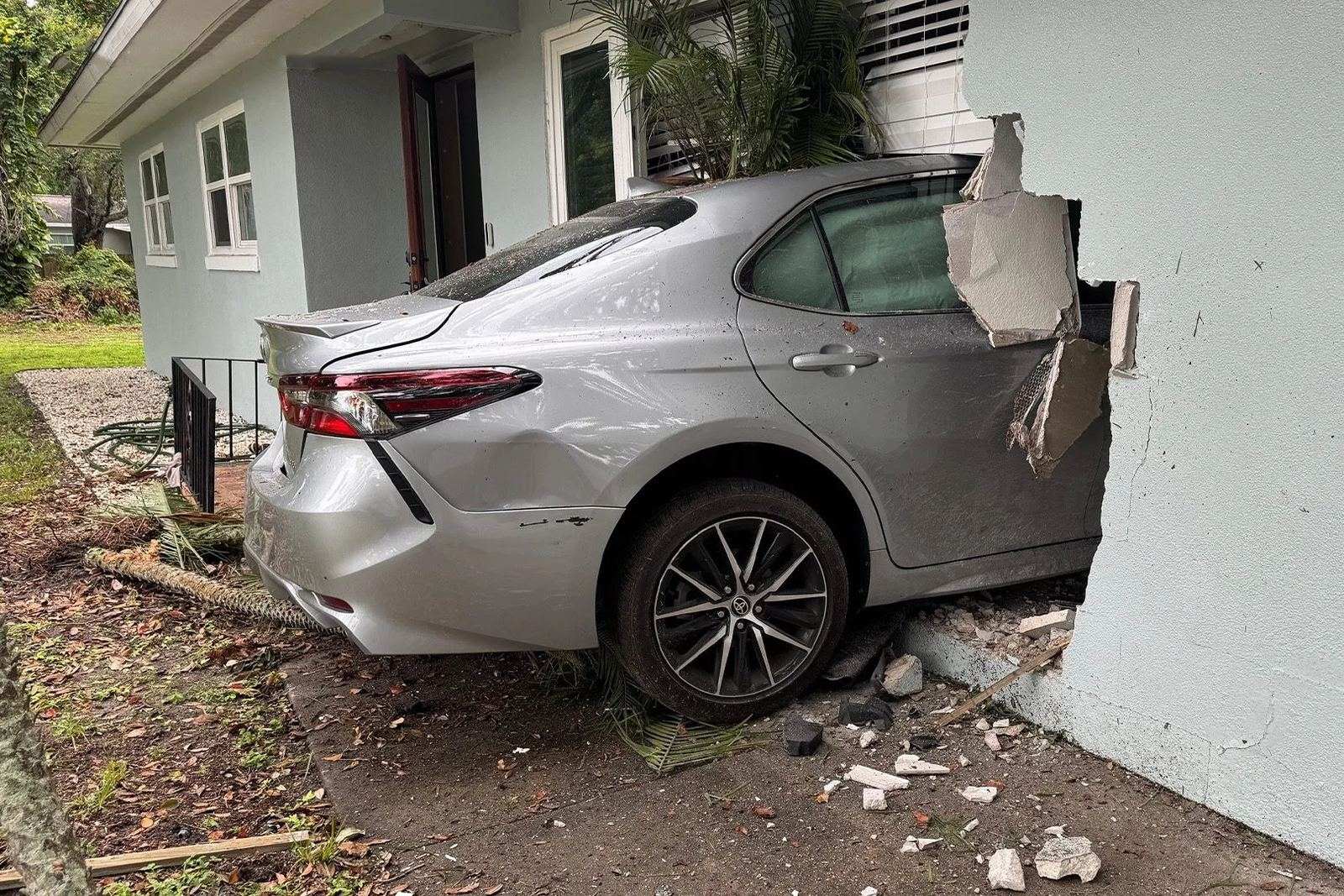 Sedan that crashed through the stucco exterior wall of a Florida home, wall and window broken open