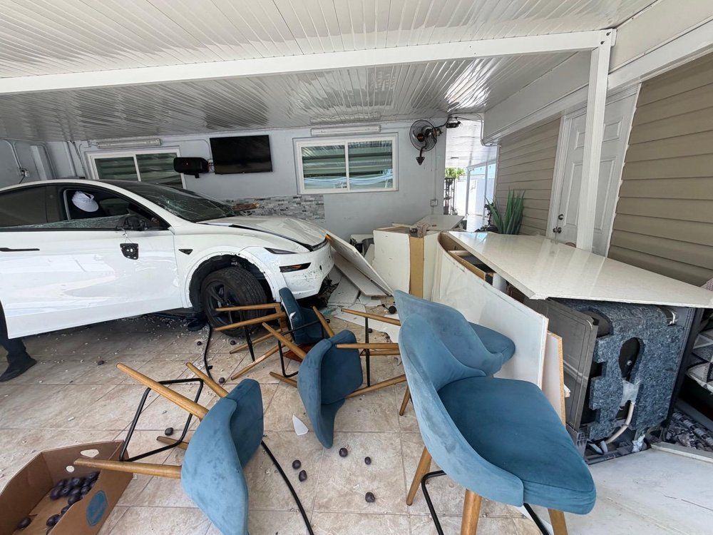Vehicle that crashed through a home's lanai into the kitchen, debris across the floor