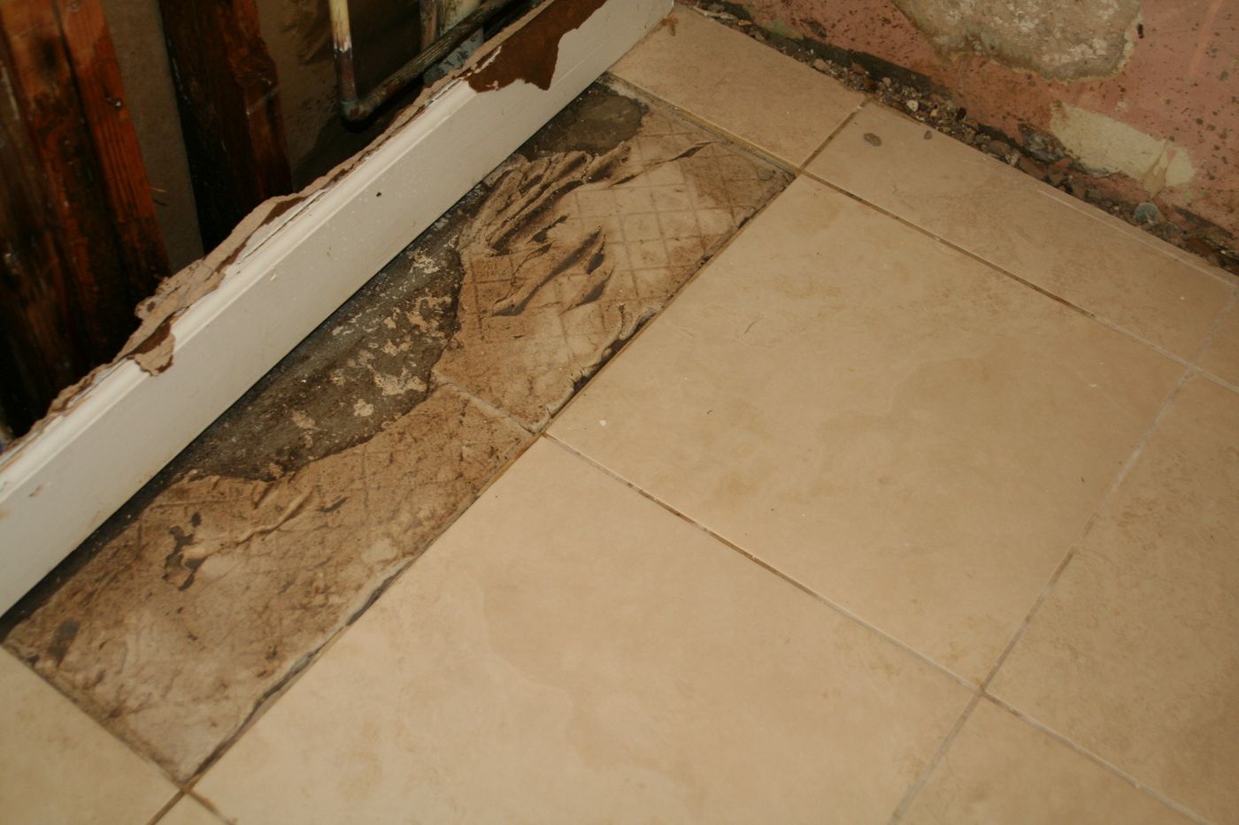 Water damage exposed behind a baseboard and wall — the kind of claim Homeland documents for Brevard County, FL property owners