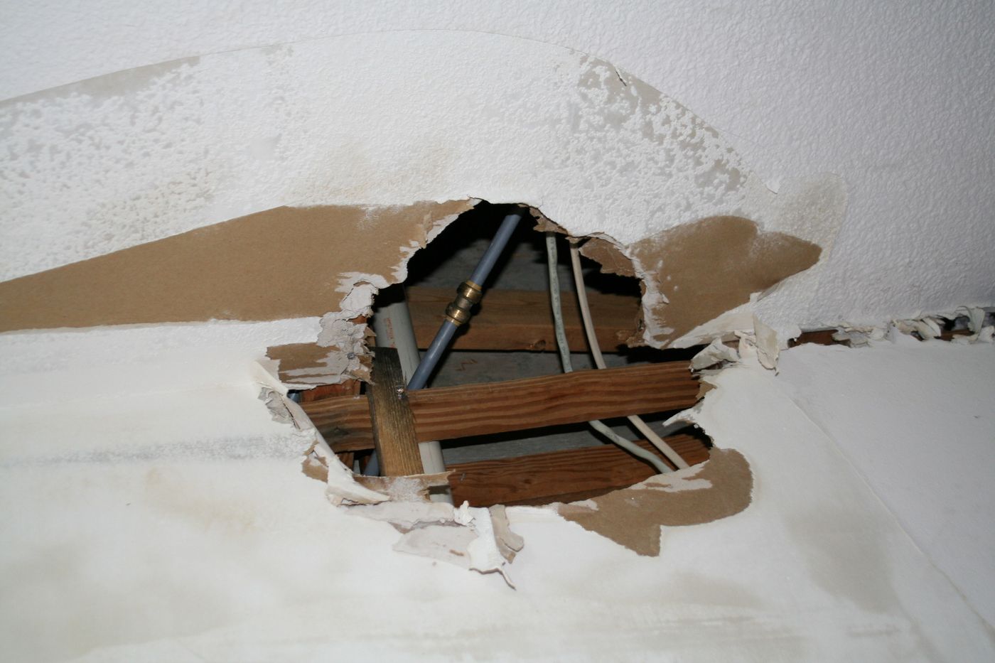 Opened ceiling cavity exposing water damage after a leak — the kind of claim Homeland documents for Charlotte County, FL property owners