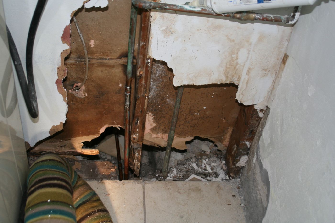 Opened wall cavity exposing water damage behind drywall — the kind of claim Homeland documents for Collier County, FL property owners
