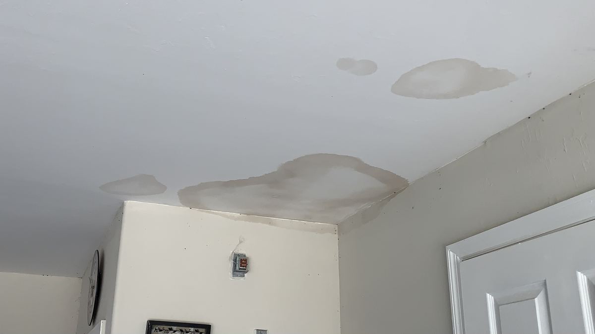 Water-stained ceiling with sagging drywall in a Central Florida home after roof damage