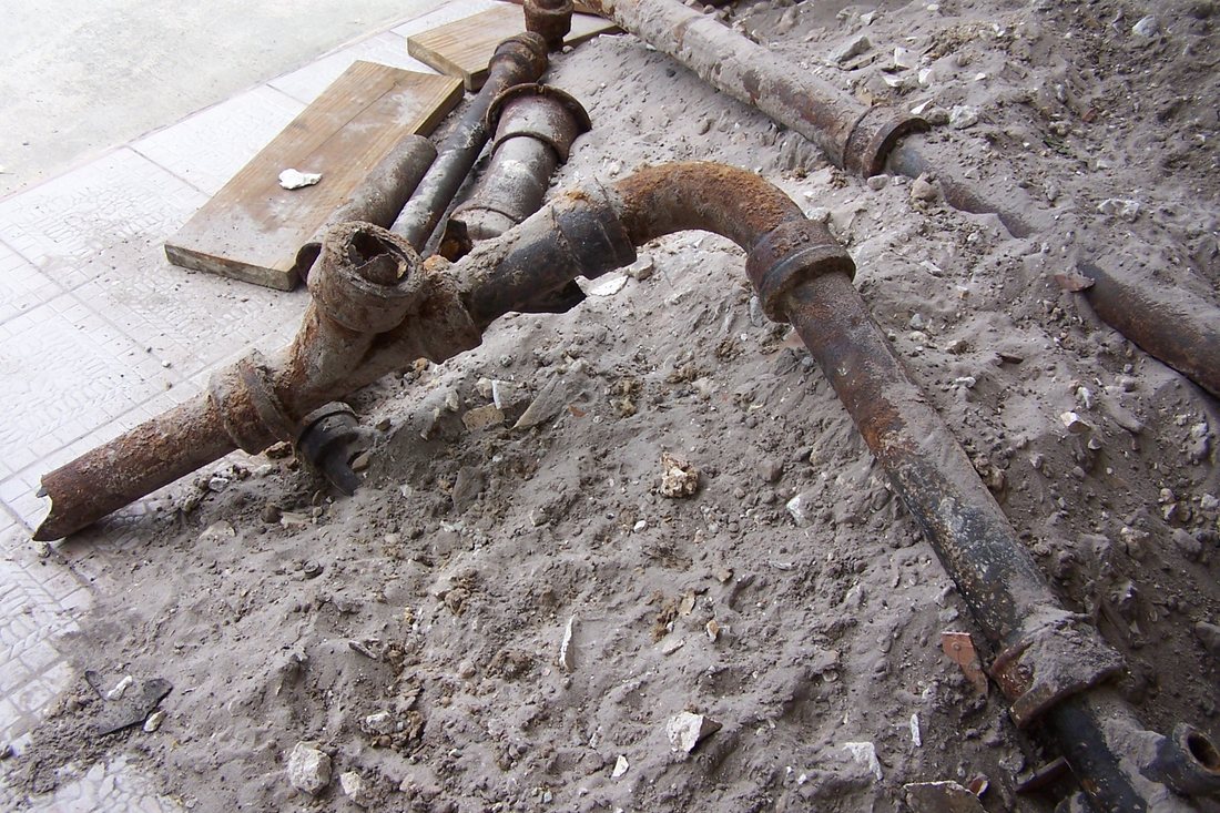 Disconnected, corroded plumbing pipes removed during a water damage repair