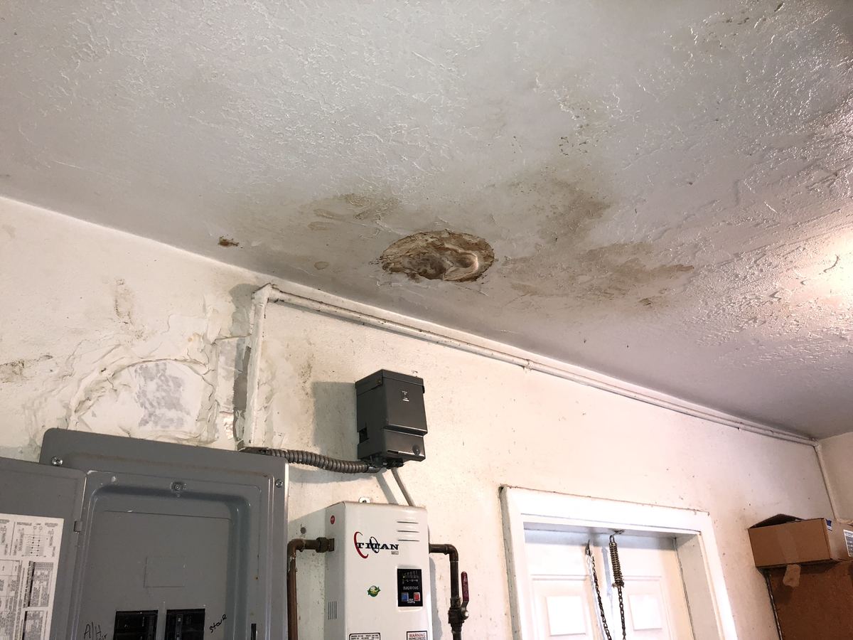 Water-damaged garage ceiling and electrical panel at a home in Tampa, FL