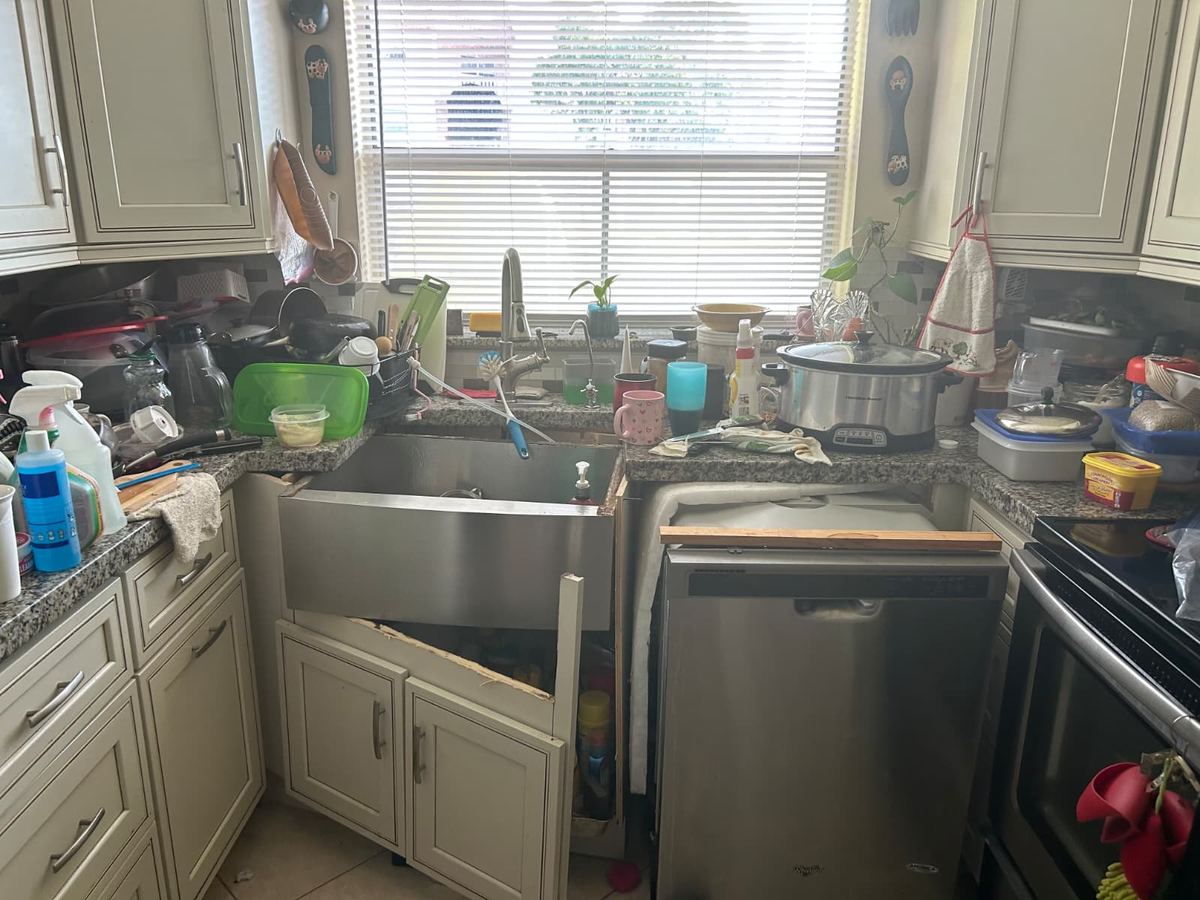 Water-damaged kitchen cabinetry in a renovated condo unit