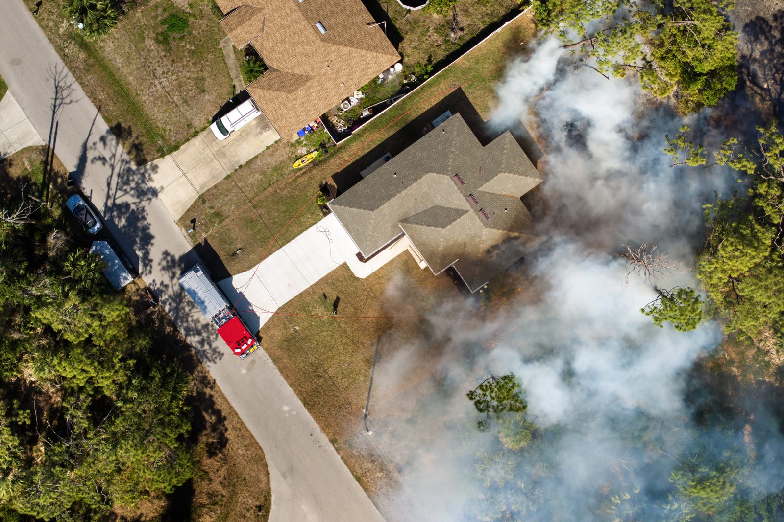 Aerial view of wildfire smoke drifting over a Florida home